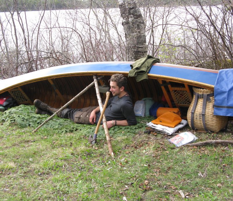 Guide Grant Hawkes always sleeps under his canoe on Allagash River Canoe Trips. Canoe Camping